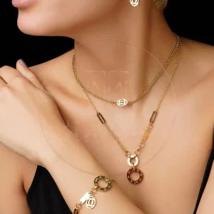 سرویس استیل دو لاین طرح کارتیه با آبکاری طلای ۱۸ عیار (گردنبند، دستبند و گوشواره)